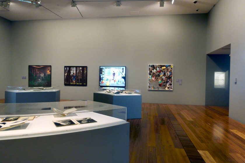 Installation view of the exhibition 'Photography: Real & Imagined' at The Ian Potter Centre: NGV Australia, Melbourne showing at rear from left to right, Gregory Crewdson's 'Untitled' (1999) from the 'Twilight' series (1998-2002); at second left, Malerie Marder's 'Untitled' (2001); and centre, Anne Zahalka's 'Sunday, 2:09pm' (1995); and at right, Alex Prager's 'Crowd #11 (Cedar and Broad Street)' (2013)