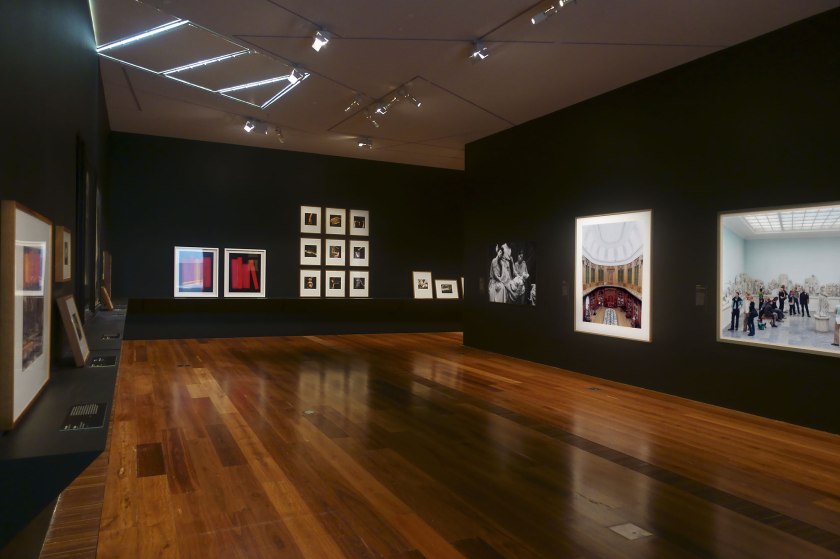 Installation view of the exhibition 'Photography: Real & Imagined' at The Ian Potter Centre: NGV Australia, Melbourne showing at rear left, Penelope Davis' 'Shelf' (2008) and 'Non-fiction (red)' (2008, below); at third right, Anne Ferran's 'Scenes on the death of nature, III' (1986); at second right, Candida Höfer's 'Teylers Museum Haarlem II' (2003, below); and at right, Thomas Struth's 'Pergamon Museum IV, Berlin' (2001)