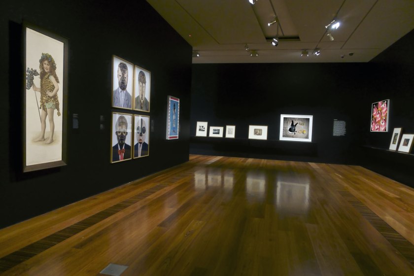 Installation view of the exhibition 'Photography: Real & Imagined' at The Ian Potter Centre: NGV Australia, Melbourne showing at left, Alice Mills' 'Joan Margaret Syme' (c. 1918); at second left, works by Edson Chagas from his 'Tipo Passe' series (2014); and at third left, Hassan Hajjaj's 'Master Cobra Mansa' (2013)