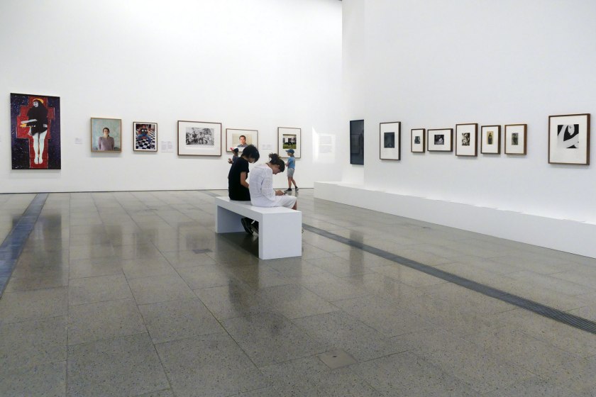 Installation view of the exhibition 'Photography: Real & Imagined' at The Ian Potter Centre: NGV Australia, Melbourne showing at left Julie Rrap's 'Persona and shadow: Madonna' (1984)