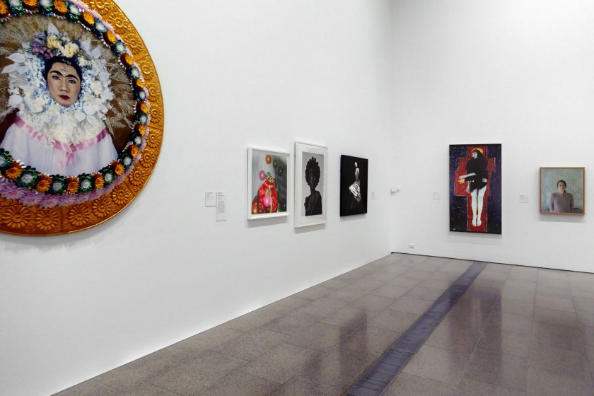 Installation view of the exhibition 'Photography: Real & Imagined' at The Ian Potter Centre: NGV Australia, Melbourne showing from left to right, Yasumasa Morimura's 'An inner dialogue with Frida Kahlo (Flower wreath and tears)' (2001); Phumzile Khanyile's 'Untitled' (2016); Zanele Muholi's 'Ntozkhe II (Parktown)' (2016, below); Ayana V. Jackson's 'How sweet the song' (2017); Julie Rrap's 'Madonna' (1984); and Siri Hayes 'Spilling pearls' (2012)